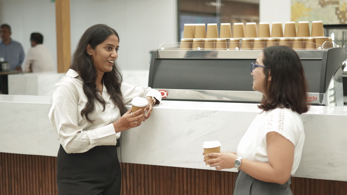 colleagues gathered around a coffee bar in the Apollo office