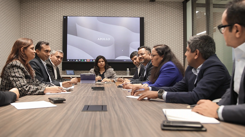 colleagues in a meeting sitting around a table 