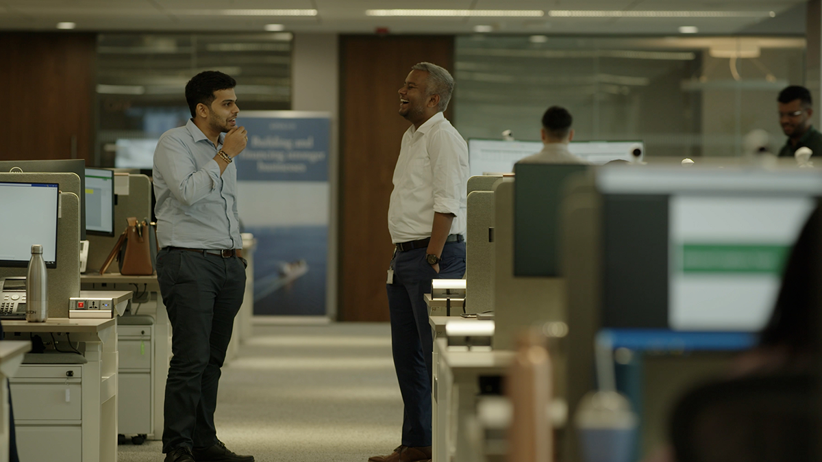 colleagues gathered around a computer in the Apollo office