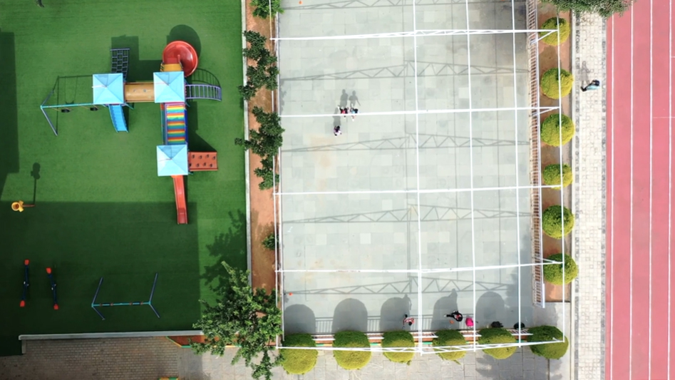 aerial view of a school playground and green grass 