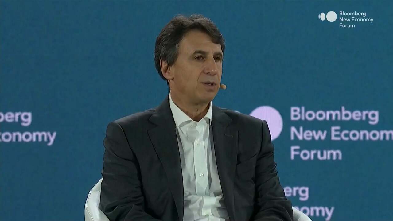 A Financial System Built for Purpose Marc Rowan, Apollo CEO, is seated on stage in a dark suit and white shirt, speaking into a headset mic at the 2025 Bloomberg New Economy Forum in Singapore, with a teal background displaying the event’s logo.