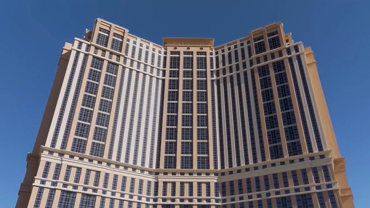 The Venetian Resort Las Vegas: Reinvigorating An Icon Wide-angle view of The Venetian Resort in Las Vegas showing its tall, symmetrical tower with grid-patterned windows and beige accents under a clear blue sky.