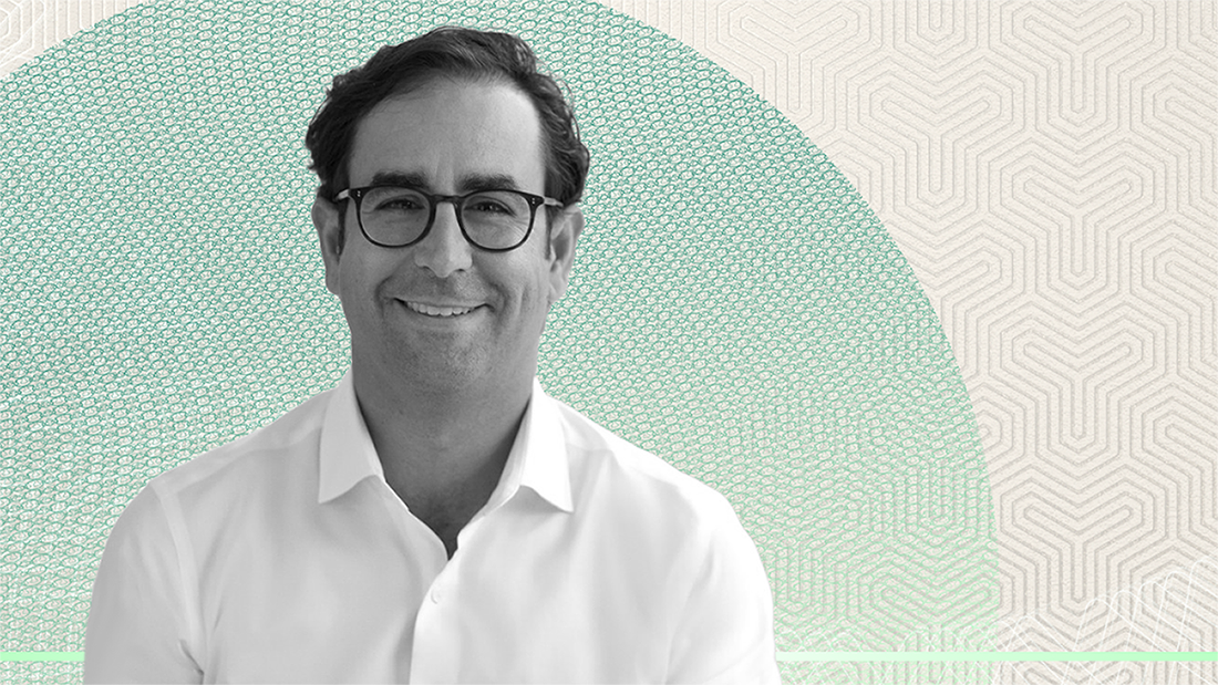 John Zito on Software, AI Disruption, and Putting Capital to Work Black-and-white portrait of Apollo's John Zito wearing glasses and a white shirt, smiling against a textured green circular background, used in an interview discussing software, AI disruption, and asset management perspectives.