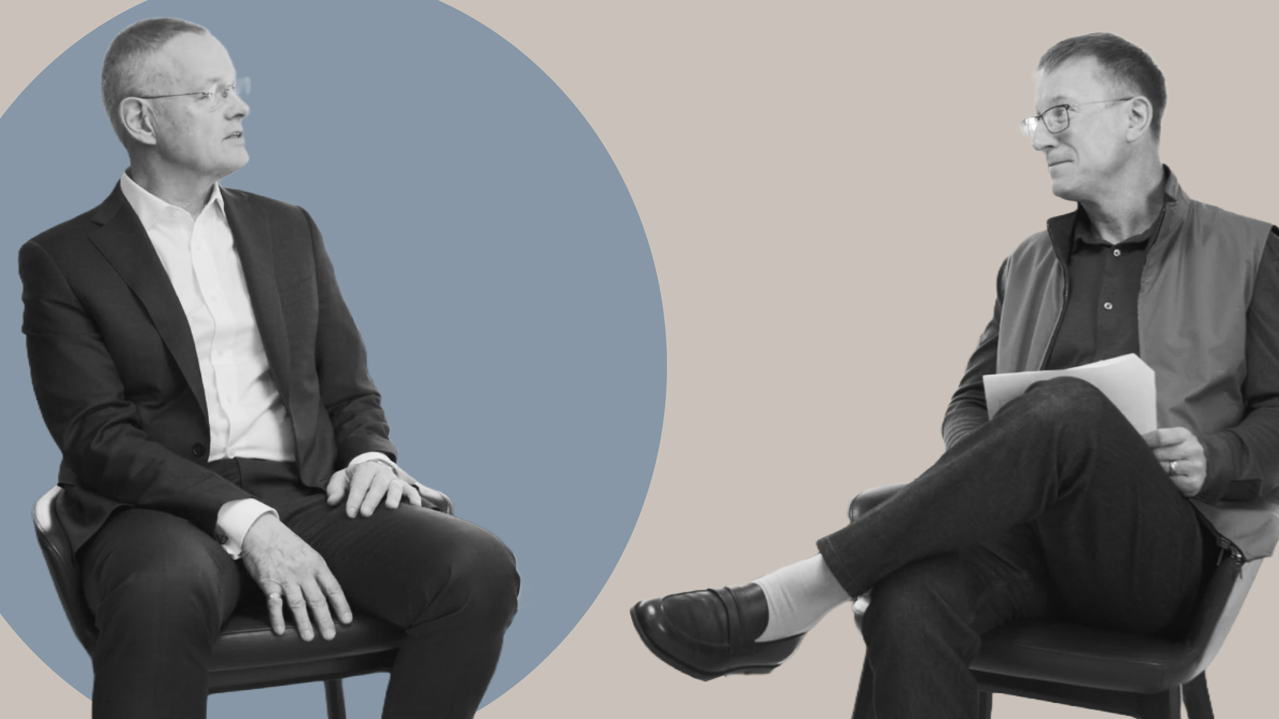 Trust, Transparency, and a Fortress Balance Sheet Two men seated facing each other in discussion, one holding papers, representing a conversation on insurance transparency, balance sheet strength, and retirement income backed by disciplined capital management.